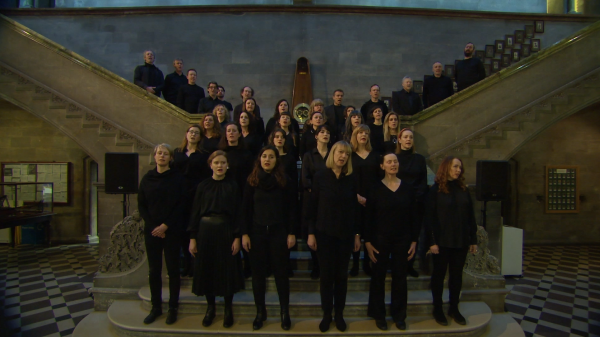 A choir dressed in black singing